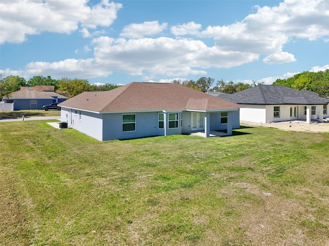 2575 SE 75th Blvd, Bushnell, FL 33513 - back of property featuring central AC unit, stucco siding, and a yard