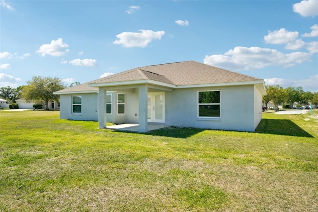 2575 SE 75th Blvd, Bushnell, FL 33513 - rear view of property featuring a lawn, stucco siding, a patio, and roof with shingles