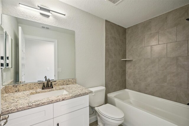 2575 SE 75th Blvd, Bushnell, FL 33513 - full bath featuring a textured ceiling, visible vents, toilet, vanity, and a textured wall