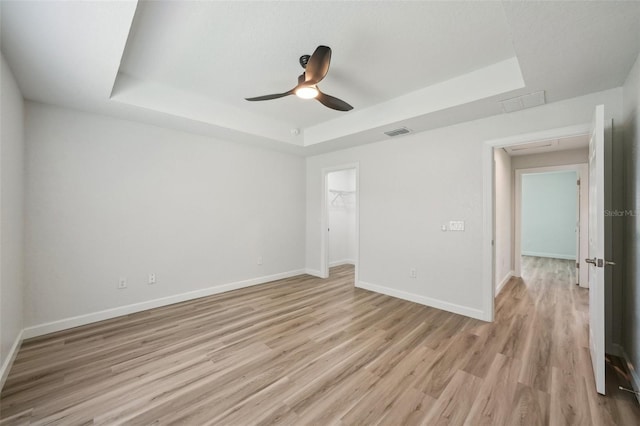 2575 SE 75th Blvd, Bushnell, FL 33513 - spare room featuring a raised ceiling, baseboards, light wood-style floors, and visible vents