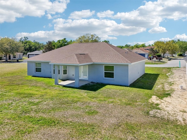 2575 SE 75th Blvd, Bushnell, FL 33513 - rear view of property featuring french doors, stucco siding, a yard, and a patio