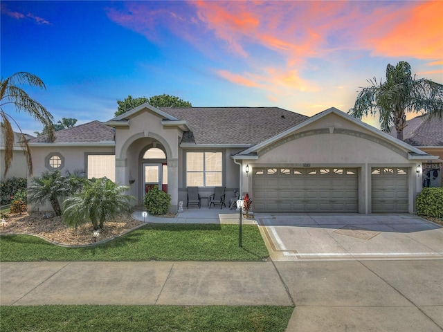 25545 Laurel Valley Rd, Leesburg, FL 34748 - ranch-style house with a garage, concrete driveway, stucco siding, and a shingled roof
