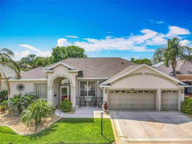 25545 Laurel Valley Rd, Leesburg, FL 34748 - ranch-style house with stucco siding, roof with shingles, driveway, a front lawn, and a garage