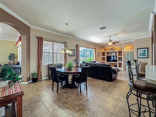 25545 Laurel Valley Rd, Leesburg, FL 34748 - tiled dining room featuring baseboards, arched walkways, ornamental molding, and a ceiling fan