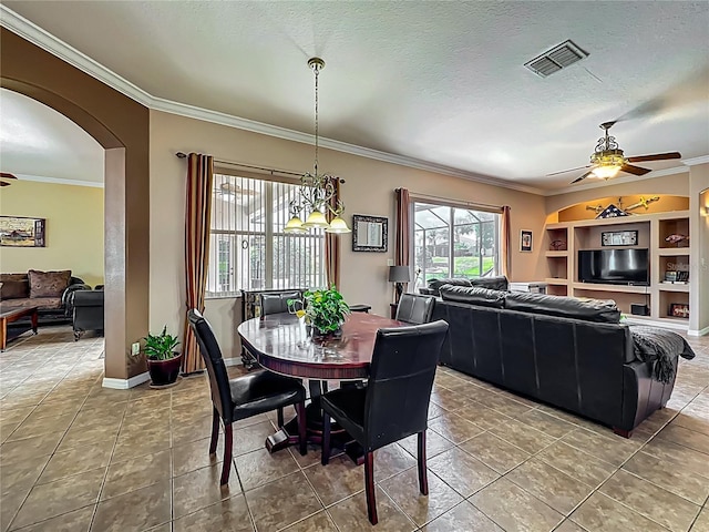 25545 Laurel Valley Rd, Leesburg, FL 34748 - dining room featuring a textured ceiling, visible vents, ornamental molding, a ceiling fan, and arched walkways