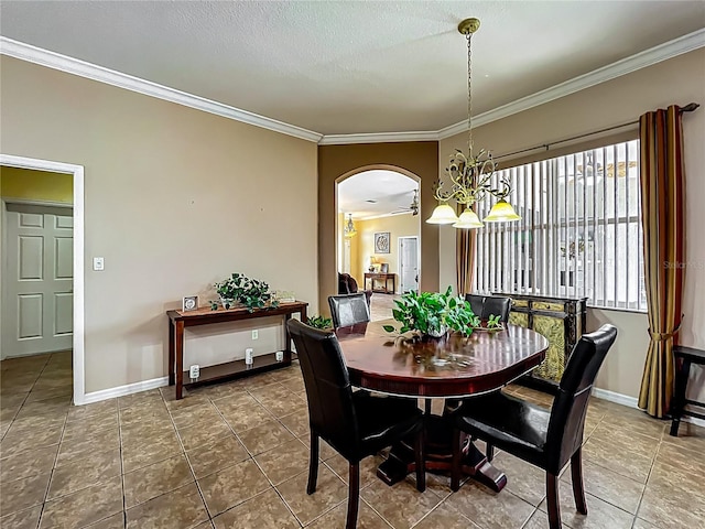 25545 Laurel Valley Rd, Leesburg, FL 34748 - tiled dining space featuring baseboards, crown molding, arched walkways, and a textured ceiling