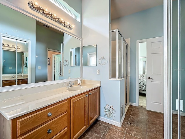 25545 Laurel Valley Rd, Leesburg, FL 34748 - bathroom featuring vanity, a shower stall, tile patterned flooring, baseboards, and visible vents