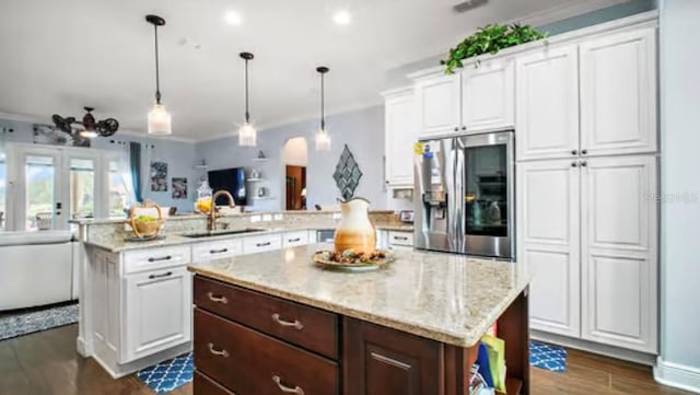17066 SE 111th Ter, Summerfield, FL 34491 - kitchen with crown molding, a sink, stainless steel fridge, a peninsula, and white cabinets