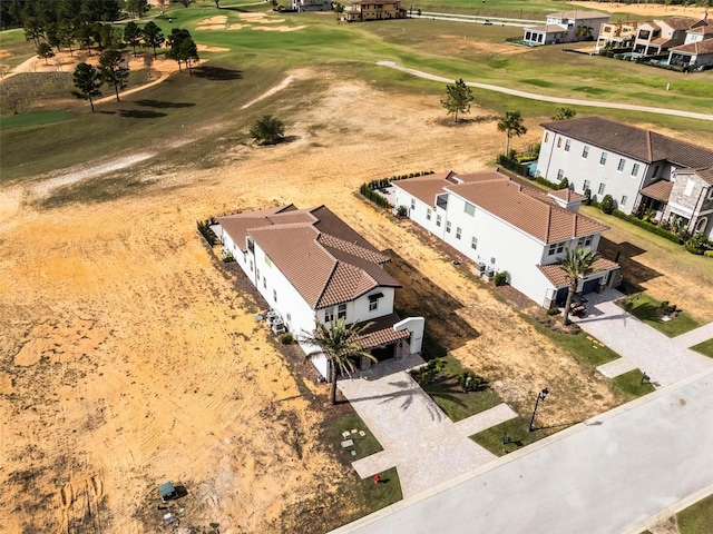 drone / aerial view with view of golf course and a residential view