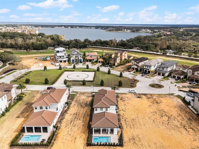 drone / aerial view with a water view and a residential view