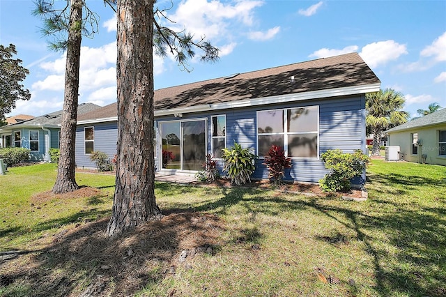 2142 Margarita Dr, The Villages, FL 32159 - back of property with central AC, roof with shingles, and a lawn