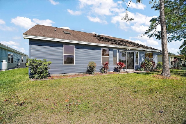 2142 Margarita Dr, The Villages, FL 32159 - rear view of property with central AC and a lawn