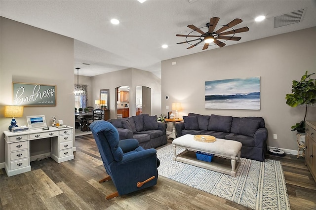 2142 Margarita Dr, The Villages, FL 32159 - living room with dark wood-type flooring, ceiling fan with notable chandelier, visible vents, arched walkways, and recessed lighting