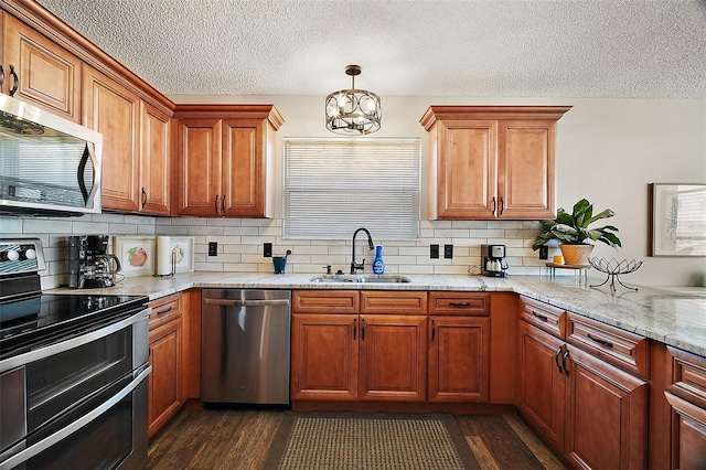 2142 Margarita Dr, The Villages, FL 32159 - kitchen with decorative backsplash, dark wood-style flooring, appliances with stainless steel finishes, a sink, and a notable chandelier