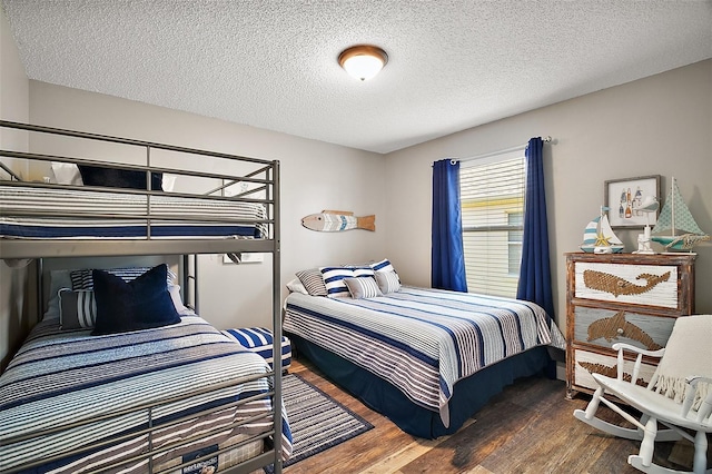 2142 Margarita Dr, The Villages, FL 32159 - bedroom featuring a textured ceiling and wood finished floors