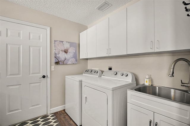 2142 Margarita Dr, The Villages, FL 32159 - clothes washing area featuring a textured ceiling, visible vents, washing machine and dryer, a sink, and cabinet space