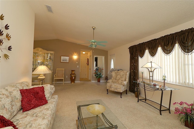 9948 SE 175th Pl, Summerfield, FL 34491 - living area featuring a textured ceiling, a ceiling fan, vaulted ceiling, visible vents, and carpet floors