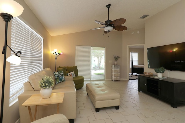living area featuring high vaulted ceiling, ceiling fan, baseboards, and visible vents