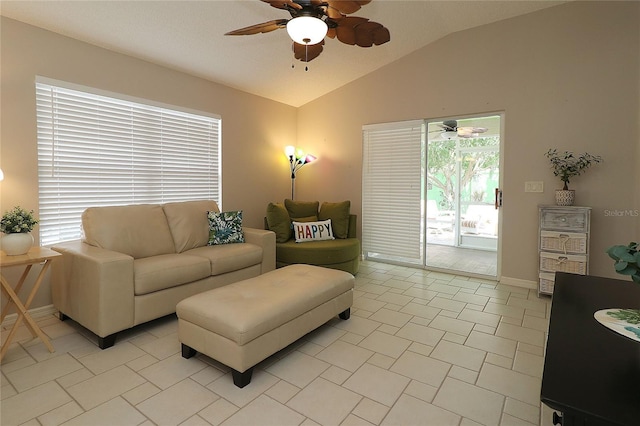 living area with light tile patterned flooring, ceiling fan, baseboards, and lofted ceiling