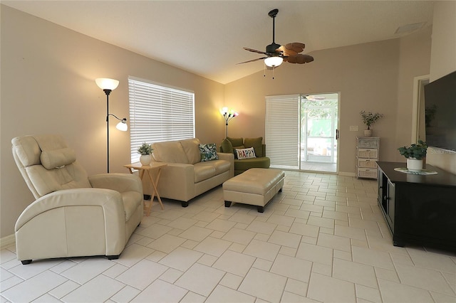 living room with light tile patterned floors, baseboards, vaulted ceiling, and ceiling fan