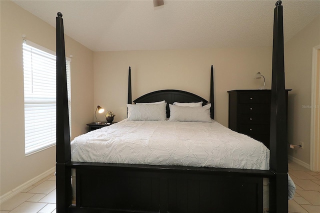 bedroom with light tile patterned floors and baseboards