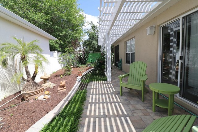 view of patio featuring fence and a pergola