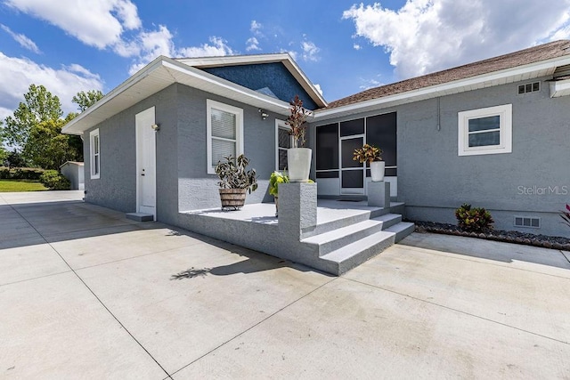 11619 Lane Park Rd, Tavares, FL 32778 - view of front of property with stucco siding and a patio