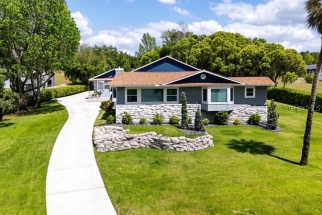11619 Lane Park Rd, Tavares, FL 32778 - view of front of property with stone siding, a front lawn, and stucco siding