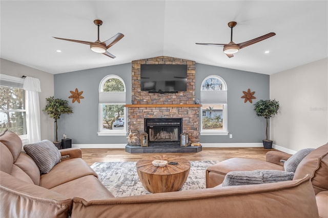 11619 Lane Park Rd, Tavares, FL 32778 - living room with ceiling fan, vaulted ceiling, wood finished floors, and a stone fireplace