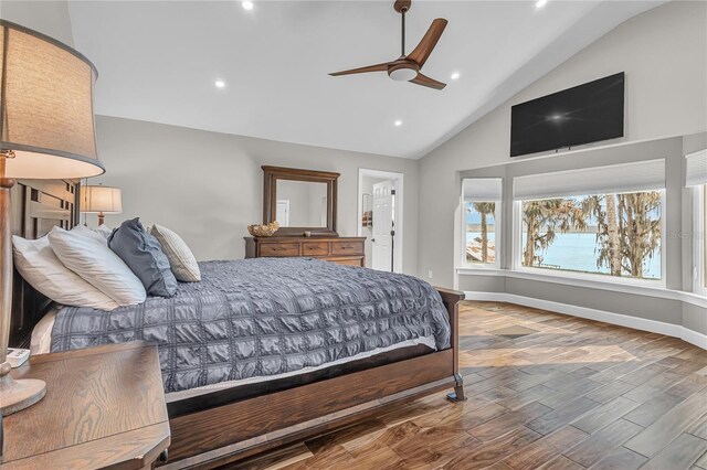 11619 Lane Park Rd, Tavares, FL 32778 - bedroom featuring wood finished floors, high vaulted ceiling, recessed lighting, ensuite bath, and ceiling fan
