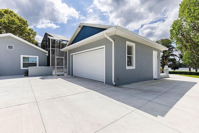 11619 Lane Park Rd, Tavares, FL 32778 - view of side of property featuring glass enclosure, driveway, and stucco siding