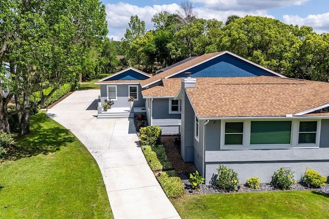 11619 Lane Park Rd, Tavares, FL 32778 - view of front of property with roof with shingles, a front lawn, stucco siding, and driveway