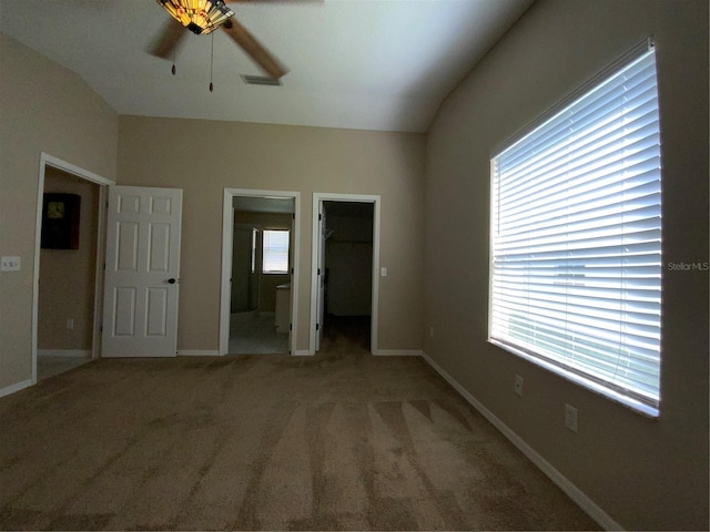 664 San Pedro Dr, The Villages, FL 32159 - unfurnished bedroom featuring vaulted ceiling, a closet, a spacious closet, baseboards, and carpet