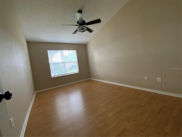 664 San Pedro Dr, The Villages, FL 32159 - spare room featuring a ceiling fan, a textured ceiling, lofted ceiling, light wood-style flooring, and baseboards