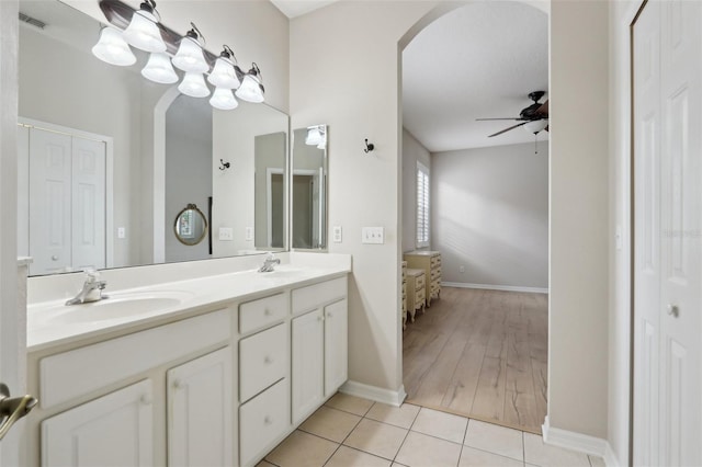 bathroom featuring double vanity, ceiling fan, tile patterned flooring, and a sink