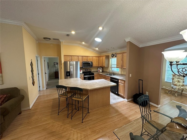 725 Beldon Ct, The Villages, FL 32162 - kitchen with stainless steel appliances, healthy amount of natural light, a center island, light wood-style flooring, and a textured ceiling