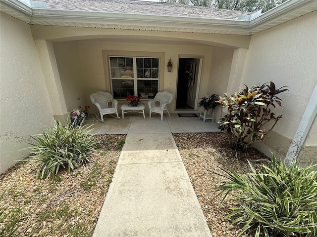 725 Beldon Ct, The Villages, FL 32162 - doorway to property featuring roof with shingles and stucco siding