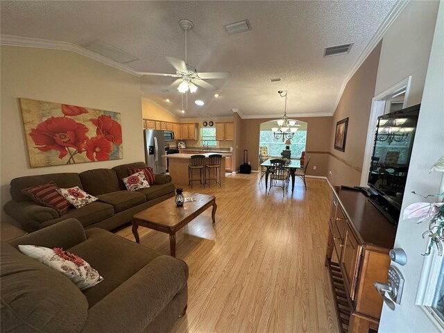 725 Beldon Ct, The Villages, FL 32162 - living area with vaulted ceiling, light wood-style flooring, a textured ceiling, a chandelier, and a ceiling fan
