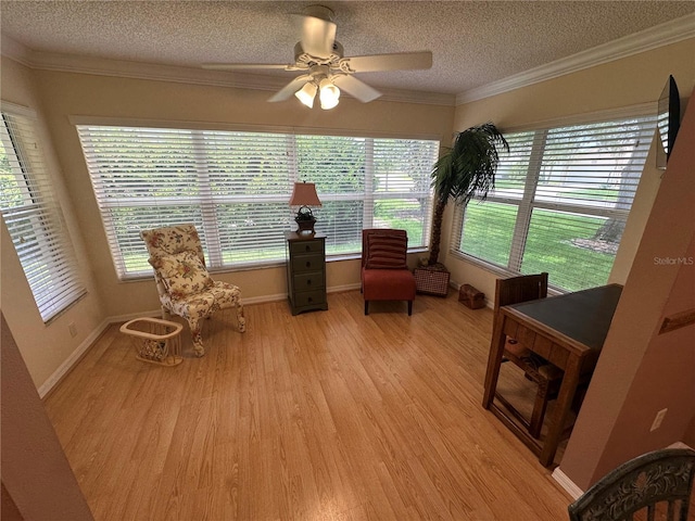 725 Beldon Ct, The Villages, FL 32162 - living area featuring a textured ceiling, light wood-style flooring, a ceiling fan, plenty of natural light, and crown molding