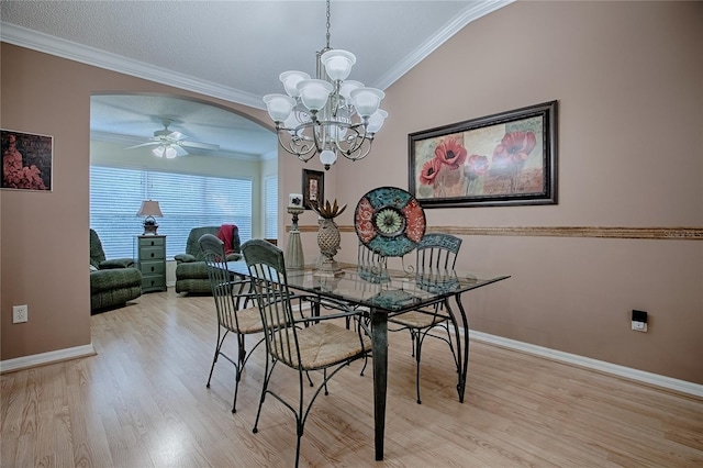 725 Beldon Ct, The Villages, FL 32162 - dining area featuring light wood-type flooring, ceiling fan, a chandelier, ornamental molding, and arched walkways