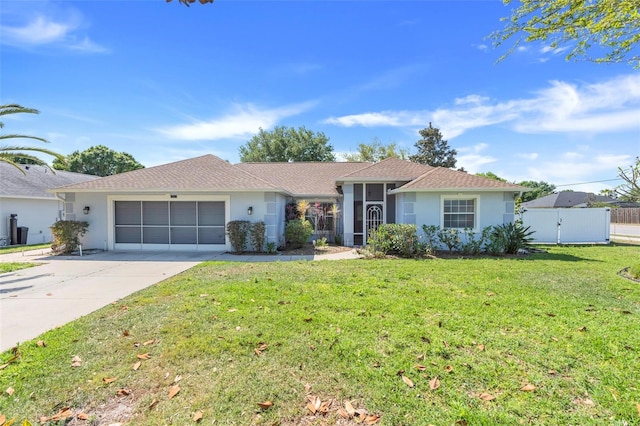 ranch-style house with a garage, stucco siding, driveway, and a front yard