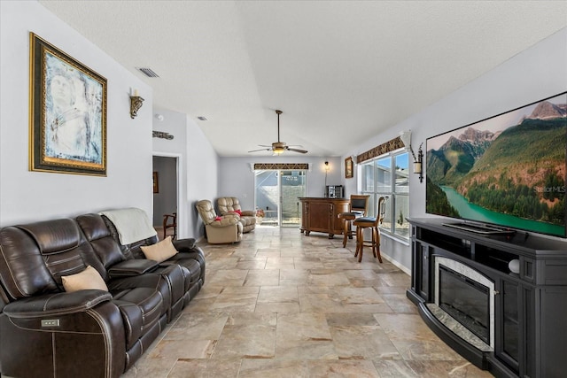 1917 Peachtree Ave, The Villages, FL 32162 - living area featuring light stone finish flooring, vaulted ceiling, and ceiling fan