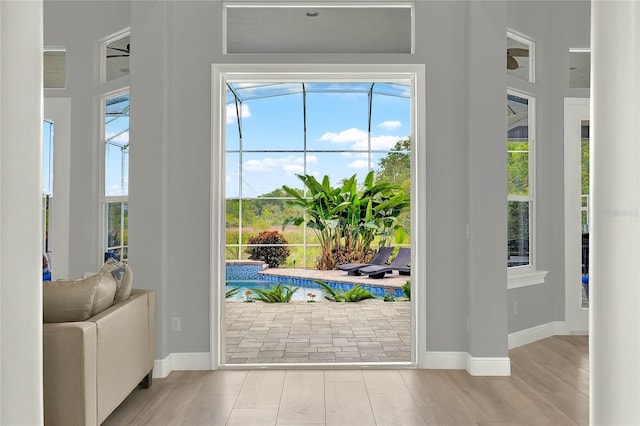 13112 Luntz Point Ln, Windermere, FL 34786 - doorway to outside with baseboards, a sunroom, and wood finished floors