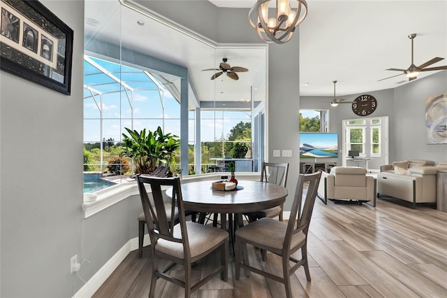 13112 Luntz Point Ln, Windermere, FL 34786 - dining space featuring a ceiling fan, wood finished floors, a sunroom, and baseboards