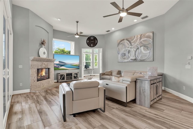 13112 Luntz Point Ln, Windermere, FL 34786 - living area with a ceiling fan, light wood-style floors, baseboards, a premium fireplace, and recessed lighting