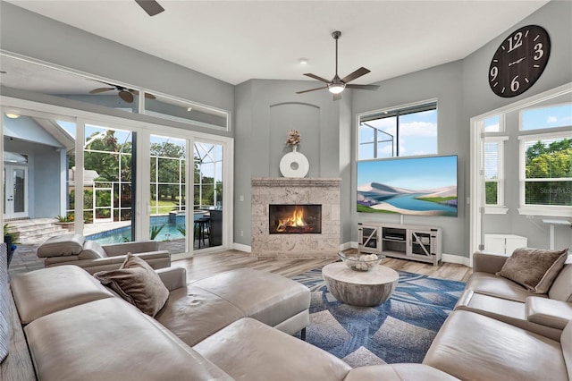13112 Luntz Point Ln, Windermere, FL 34786 - living area featuring ceiling fan, wood finished floors, a fireplace, and baseboards