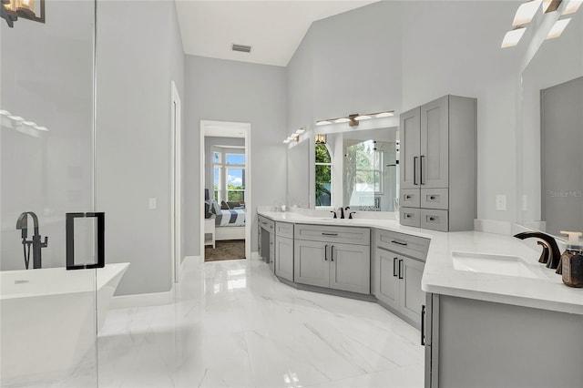 13112 Luntz Point Ln, Windermere, FL 34786 - bathroom with vanity, a freestanding tub, ensuite bathroom, marble finish flooring, and a high ceiling