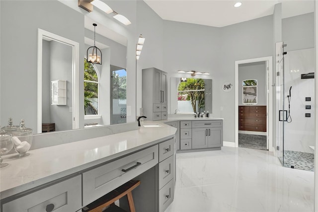 13112 Luntz Point Ln, Windermere, FL 34786 - bathroom with marble tiled floors, a stall shower, two vanities, and a chandelier