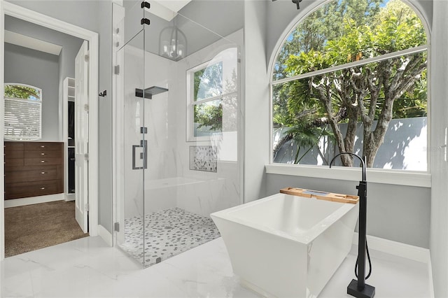 13112 Luntz Point Ln, Windermere, FL 34786 - full bathroom with a marble finish shower, a freestanding tub, and baseboards