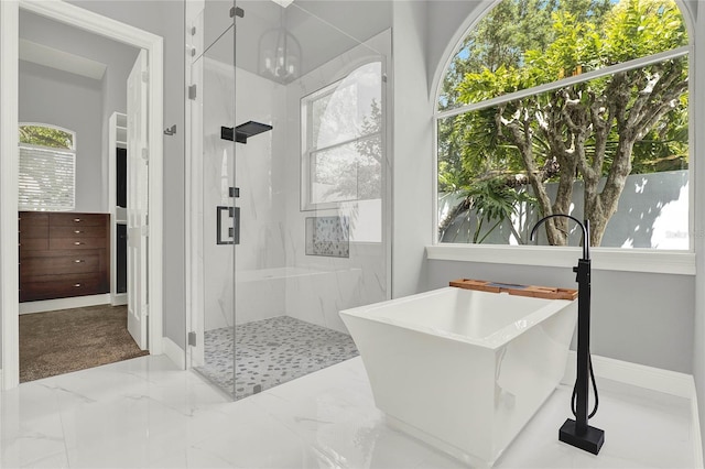 13112 Luntz Point Ln, Windermere, FL 34786 - bathroom featuring a marble finish shower, a freestanding tub, baseboards, and marble finish flooring